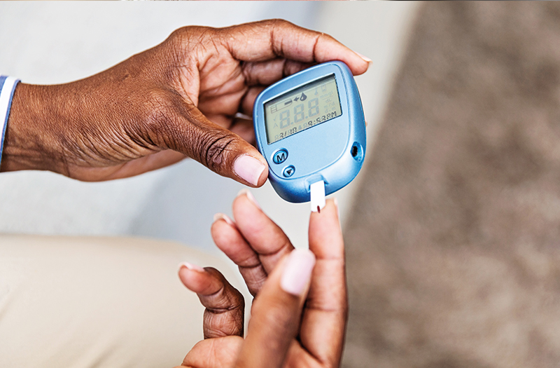 Person using a blood glucose monitor