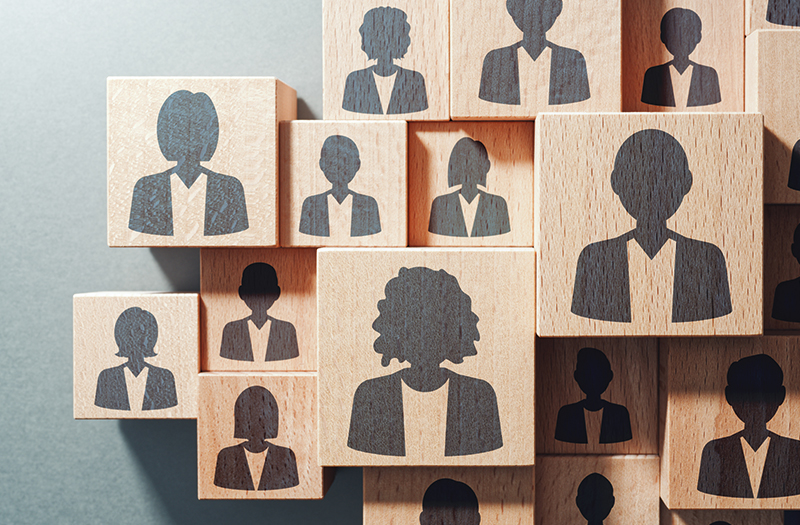 Multiple wooden blocks each showcasing a silhouette of an employee