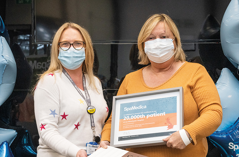 SpaMedica Manchester's Hospital manager presenting a certificate to a happy SpaMedica patient for being the hospital's 20,000th patient