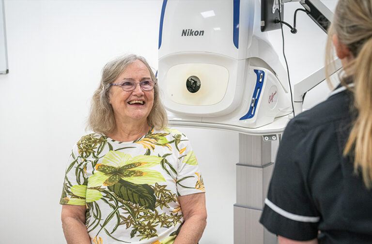 Delighted SpaMedica patient talking to a SpaMedica employee in diagnostics room