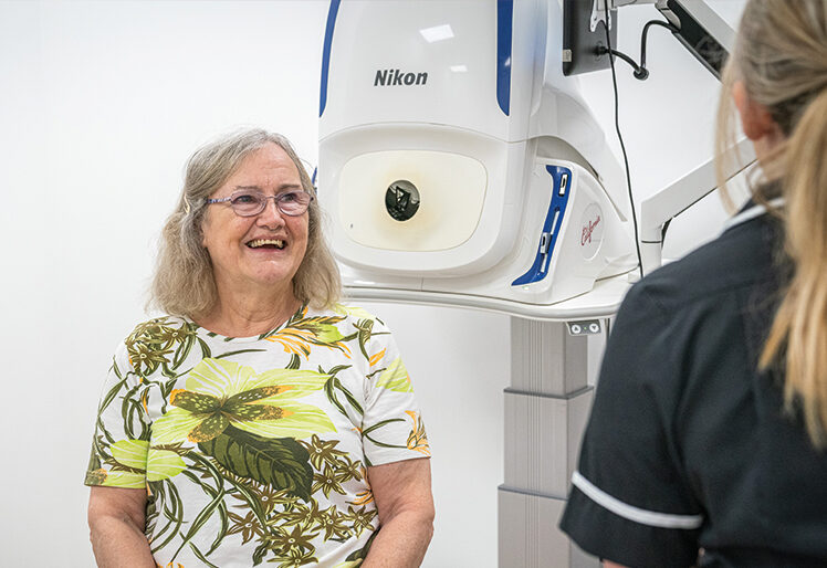 Delighted SpaMedica patient talking to a SpaMedica employee in diagnostics room