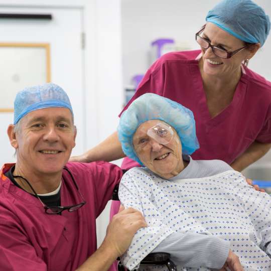 SpaMedica consultant and scrub nurse laughing and smiling with a SpaMedica patient after surgery