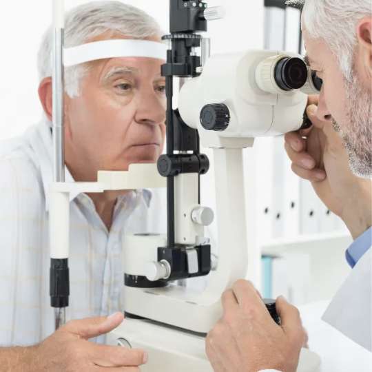 Optometrist examining the eyes of patient with a slit lamp
