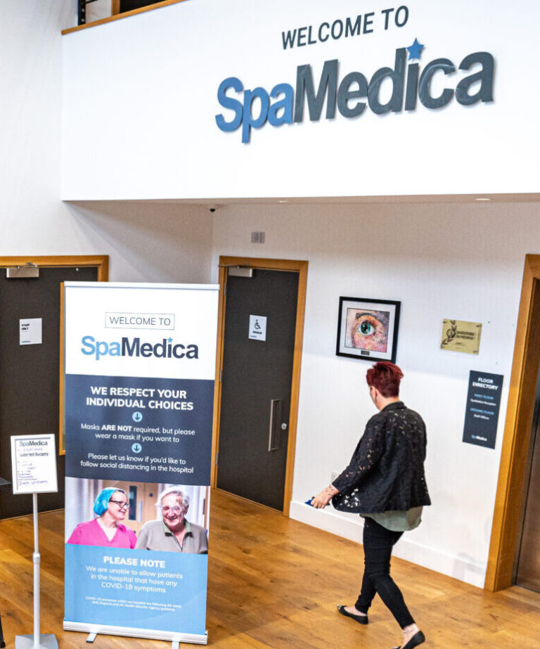 SpaMedica reception room with Covid signage banner