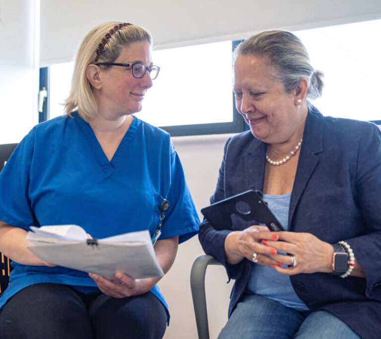 Nurse and patient, with nurse showing patient information leaflet