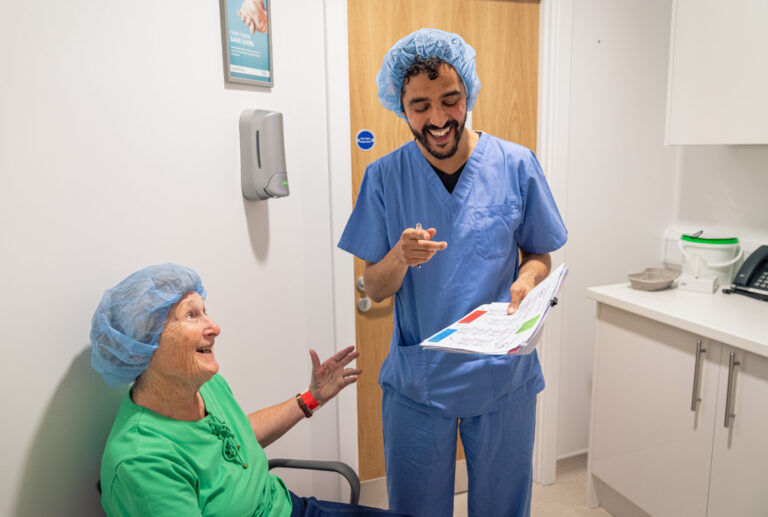 Happy SpaMedica patient having a conversation with a smiling SpaMedica surgeon