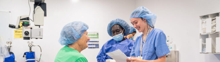 SpaMedica nurses laughing away with patient checking details before surgery