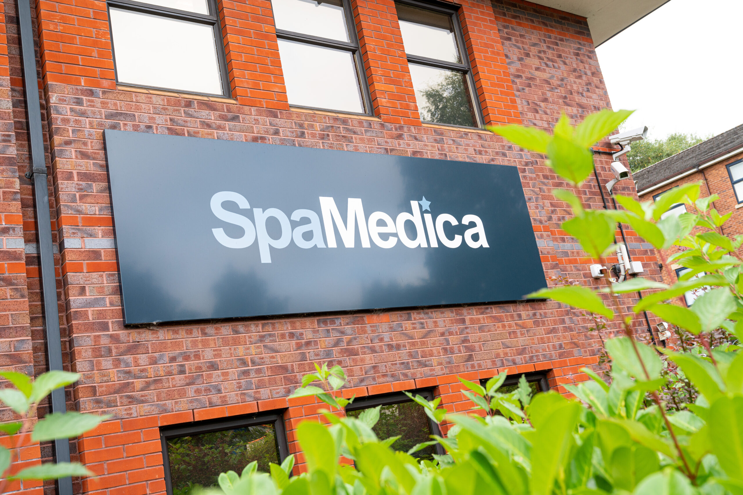 SpaMedica logo on the exterior of a SpaMedica hospital building