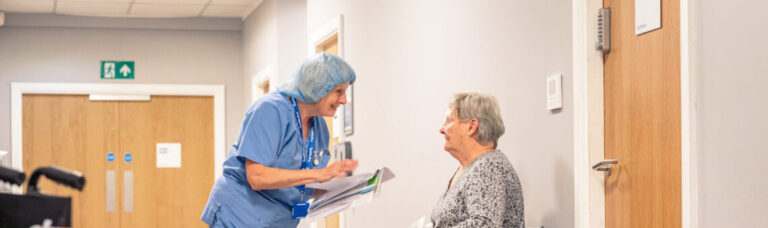 Nurse chatting to patient after eye treatment in a SpaMedica hospital