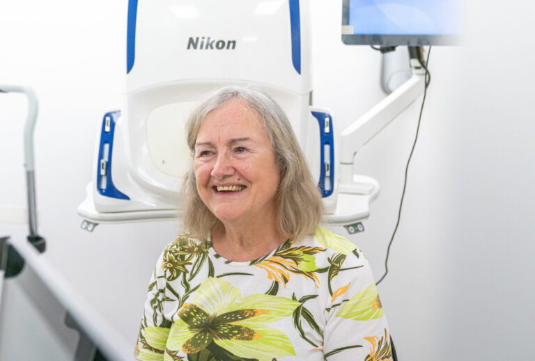 A smiling SpaMedica patient sat in the examination room