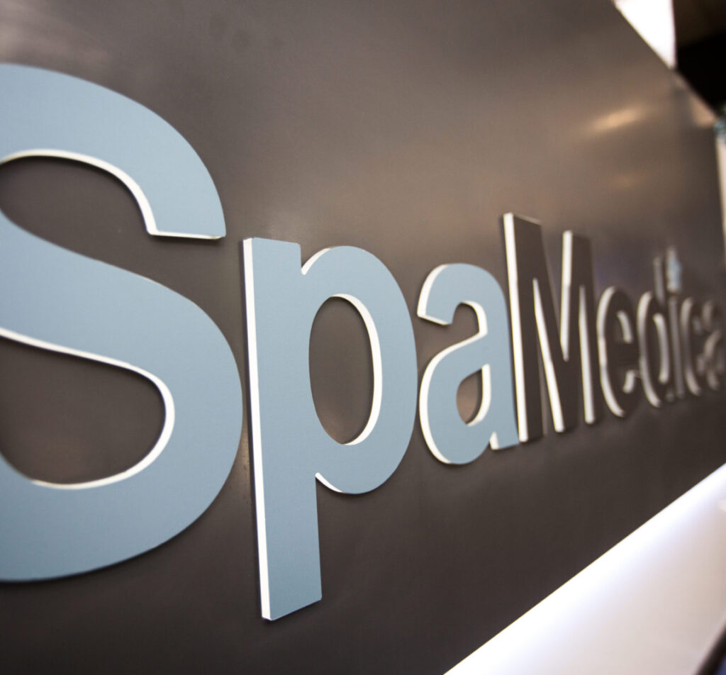 close up of the SpaMedica logo on a SpaMedica reception desk