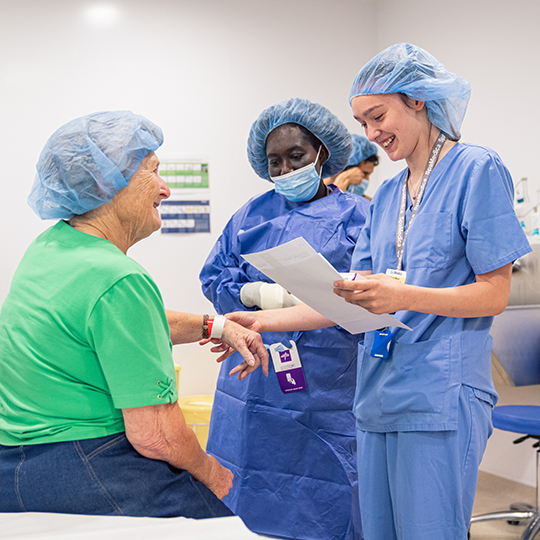 Spamedica employee checking the details of a SpaMedica patient in theatre