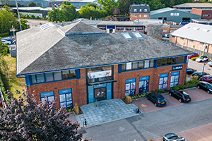 The exterior of the SpaMedica Wokingham hospital displaying images of patients and SpaMedica branding on the windows