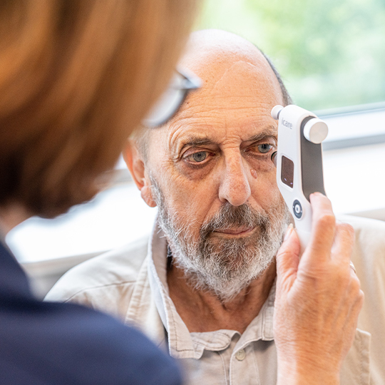 A SpaMedica nurse checking the eye fluid pressure of a SpaMedica patient using a Tonometer