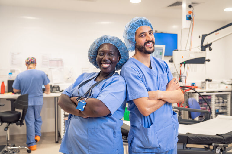 SpaMedica consultant surgeon laughing and joking with a SpaMedica scrub nurse in an operating theatre