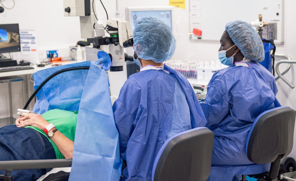 Image of a male surgeon and female scrub nurse performing cataract surgery