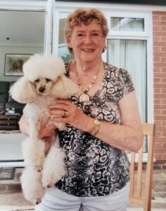 Smiling SpaMedica patient pictured with her dog