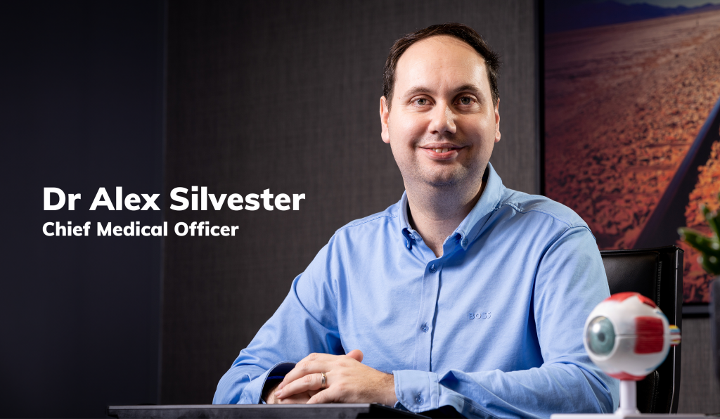Dr Alex Silvester picture sat at a desk
