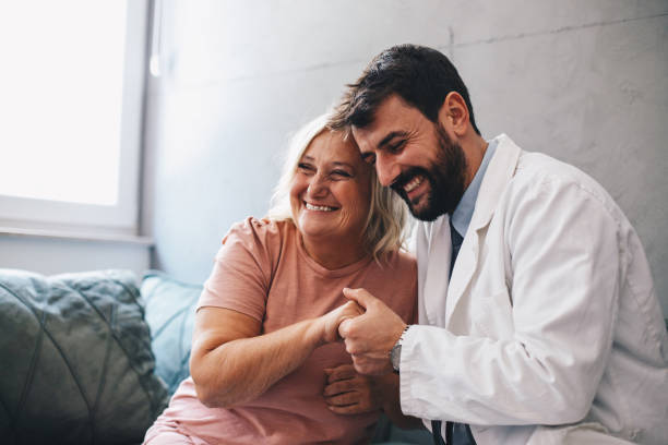 Female having happy conversation with male doctor